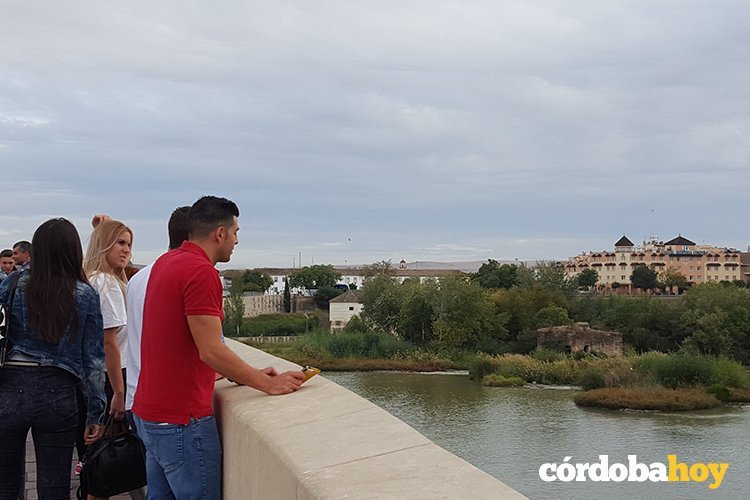 Turistas contemplando el Guadalquivir desde el Puente Romano