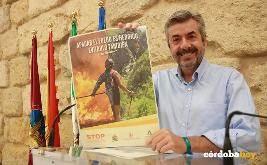 Miguel &Aacute;ngel Torrico con el cartel de la campa&ntilde;a preventiva de incendios