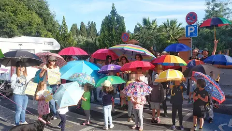 Familias del CEIP Algafequi protestan con sombrillas, paraguas y pamelas por la falta de sombras en el centro
